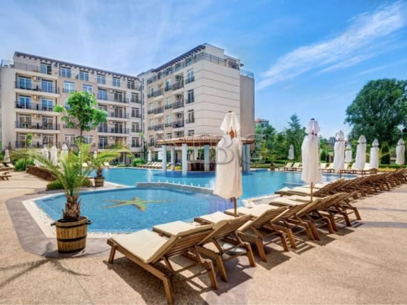 Pool view from a studio at Dawn Park, Sunny Beach with sun loungers and umbrellas.