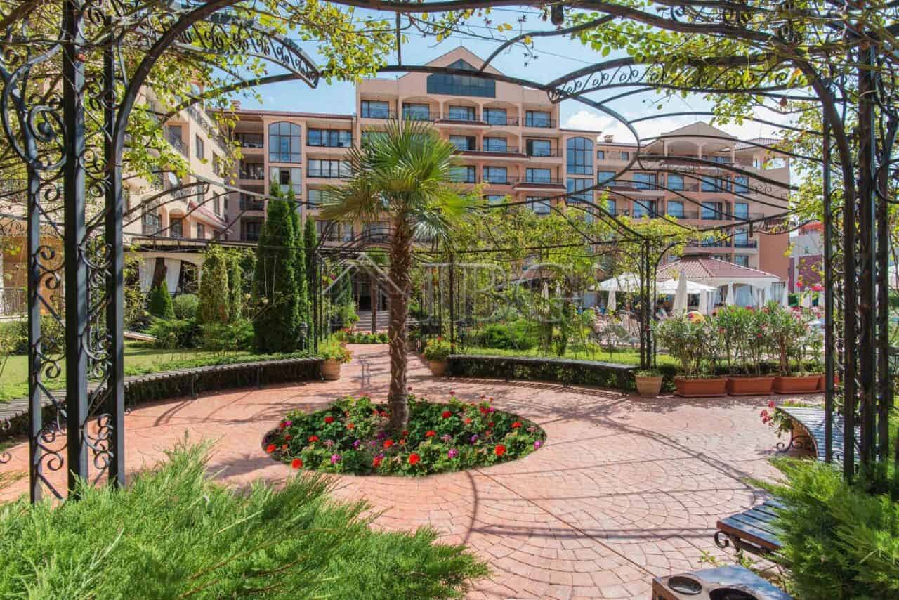 Furnished studio apartment with balcony in Diamant Residence, Sunny Beach, surrounded by lush garden.