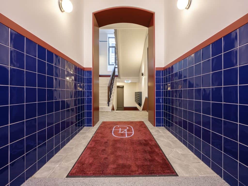 Bright hallway with staircase leading to upper floors in Marijas 4, Riga.