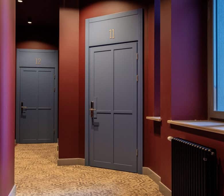 Bright hallway featuring stylish doors and vibrant wall colors in a residential property.
