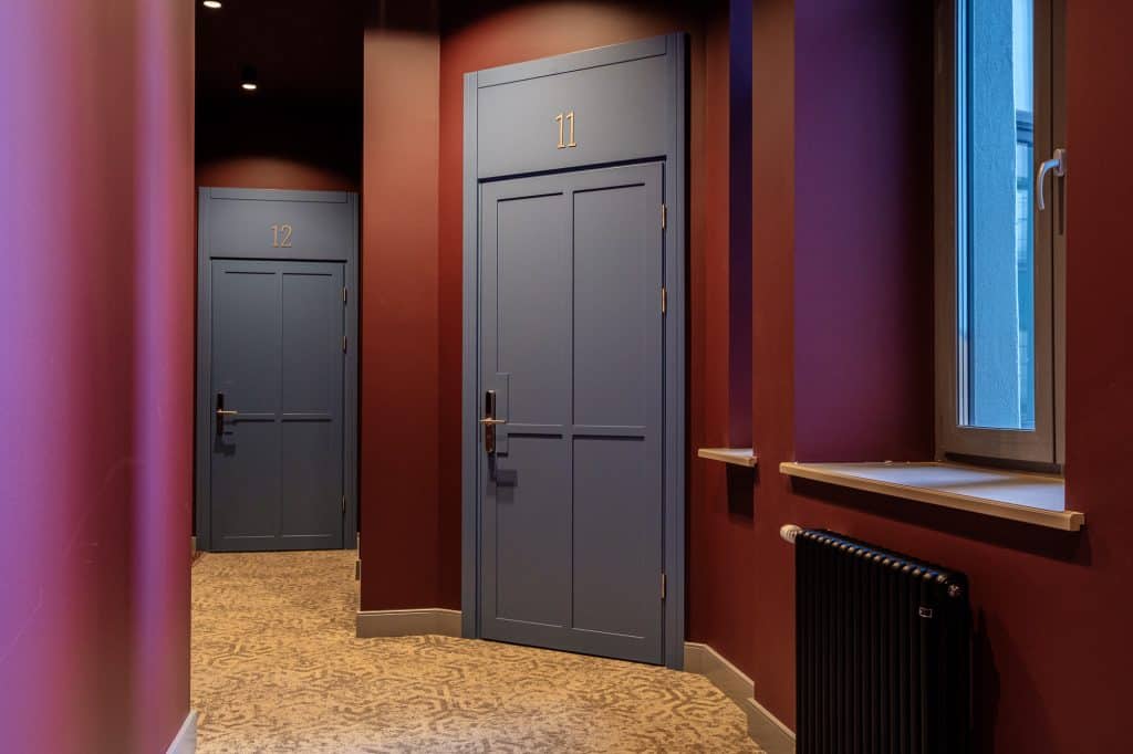 Bright hallway featuring stylish doors and vibrant wall colors in a residential property.