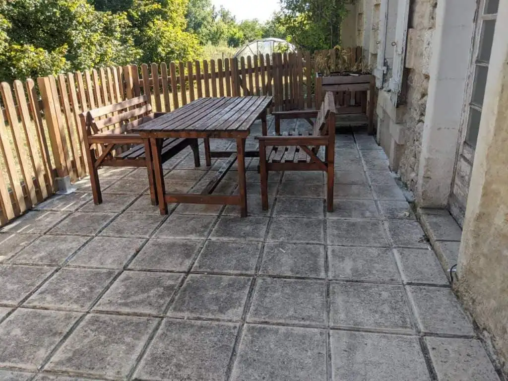 Outdoor patio with wooden table and chairs in France.