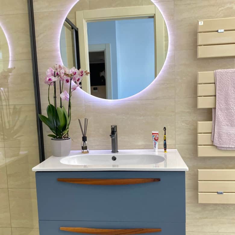 Elegant bathroom with modern mirror and lighting in Bernalda Italy.