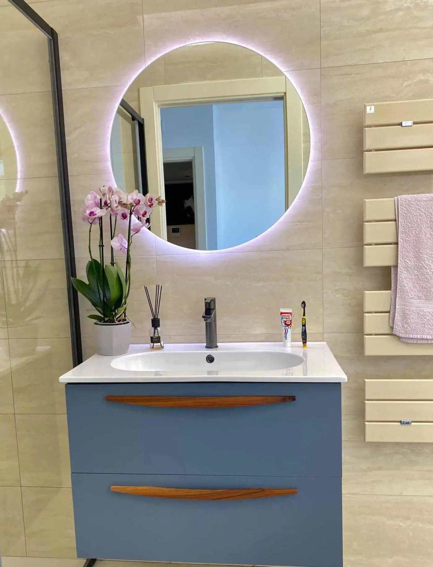 Elegant bathroom with modern mirror and lighting in Bernalda Italy.