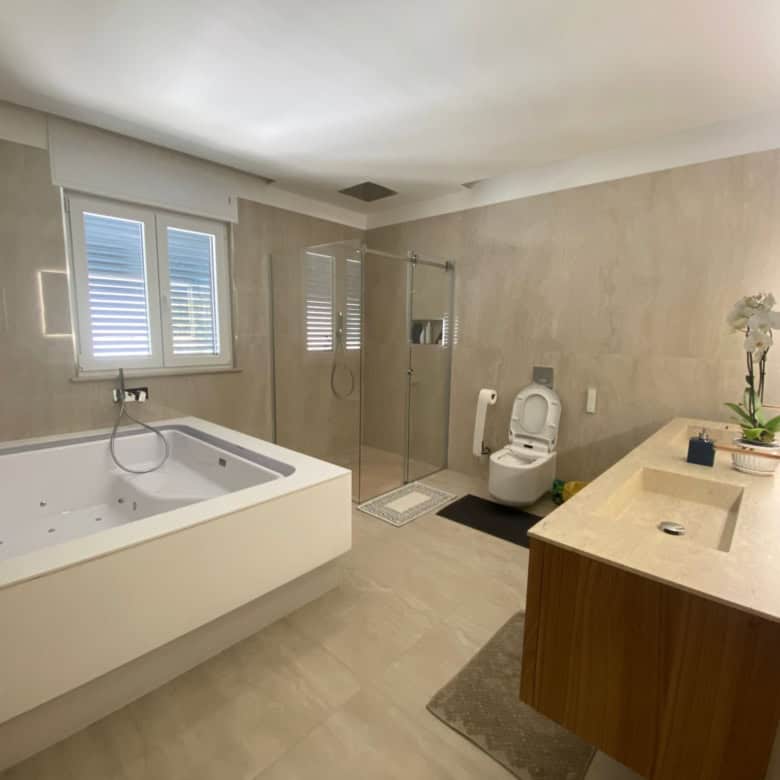 Modern bathroom with bathtub and shower in Bernalda Italy.