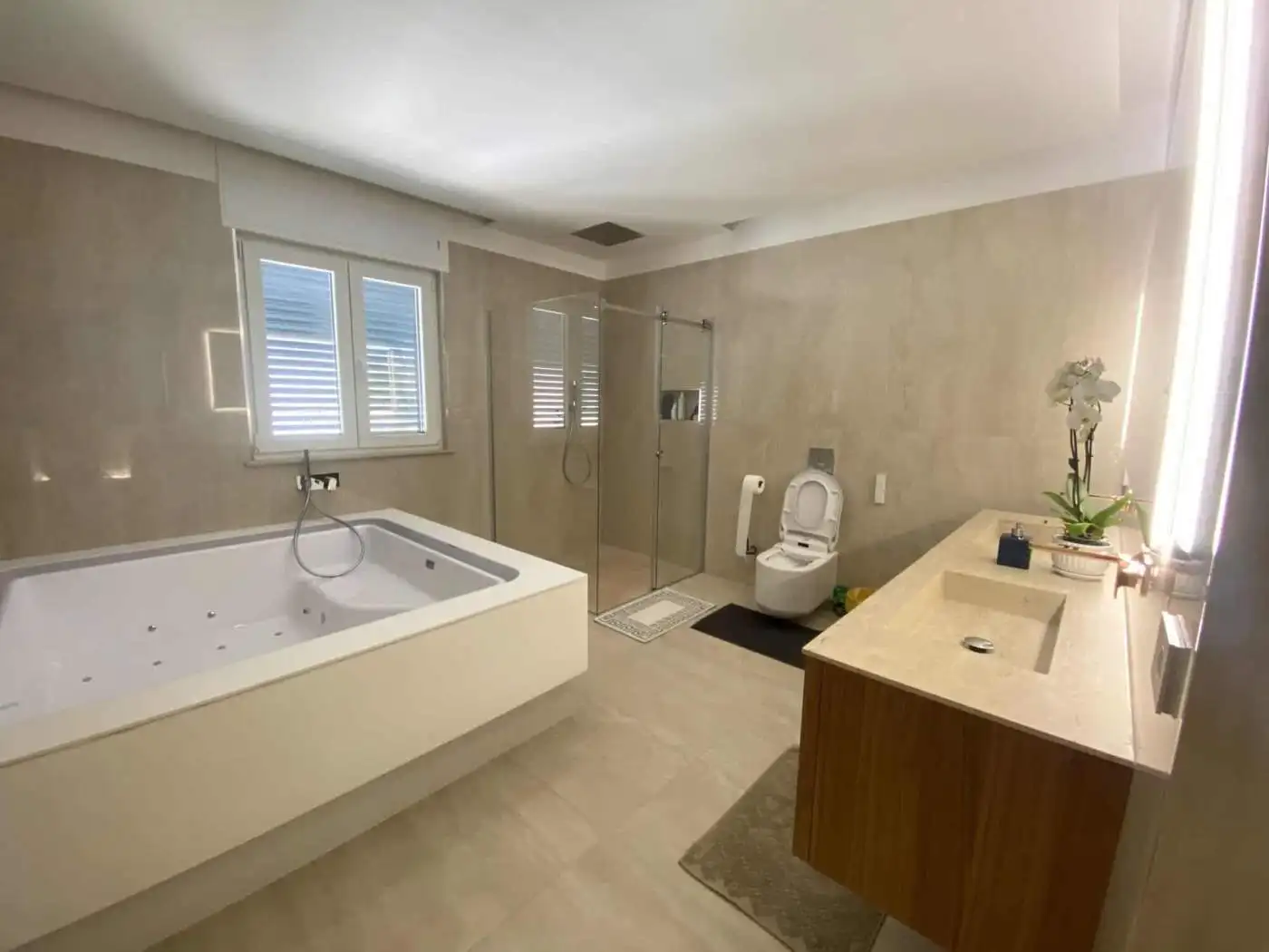 Modern bathroom with bathtub and shower in Bernalda Italy.