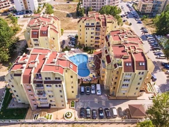 Aerial view of Sea Dreams residential complex in Sunny Beach with pool and parking area.