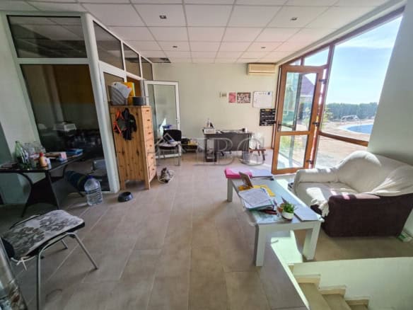 Bright, airy room with large windows and comfortable furniture.