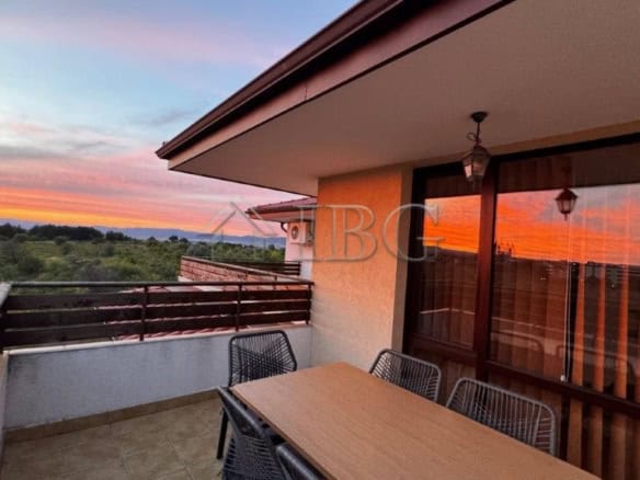 Balcony with outdoor seating and panoramic sunset view in Nessebar.