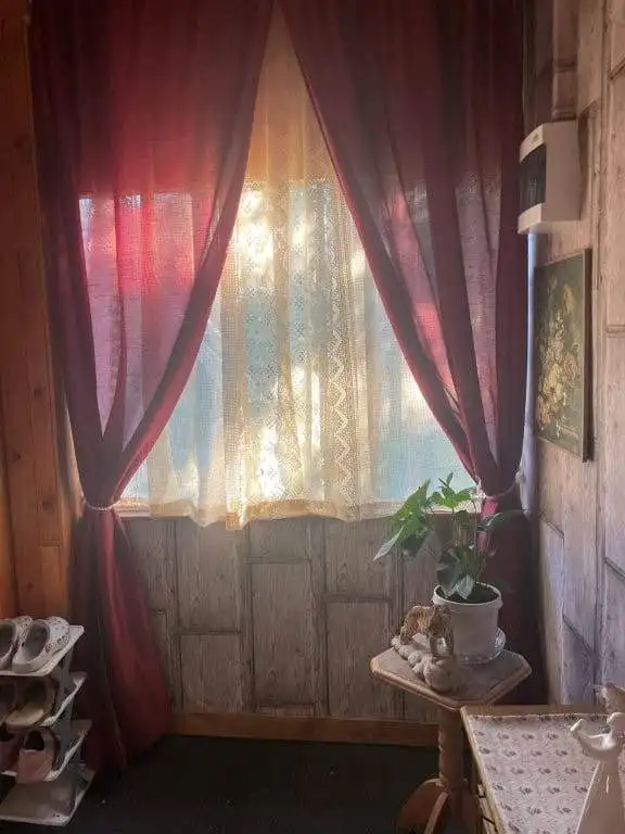 Bright window with curtains in a country house in Bulgaria.