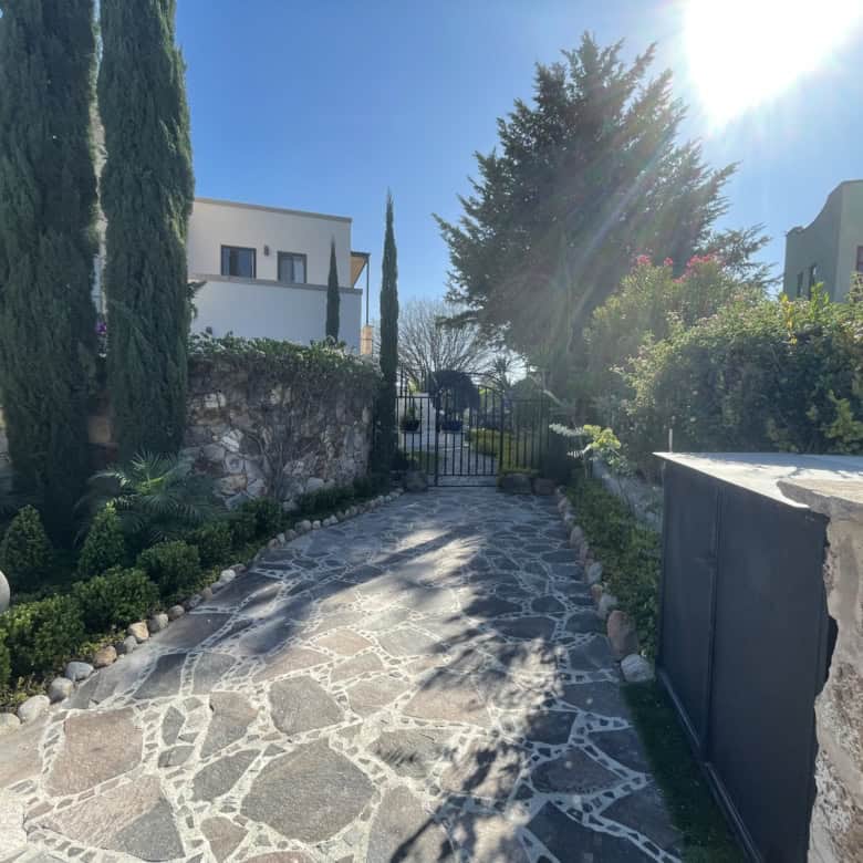 Exquisite Mediterranean garden pathway with lush greenery and stone paving.
