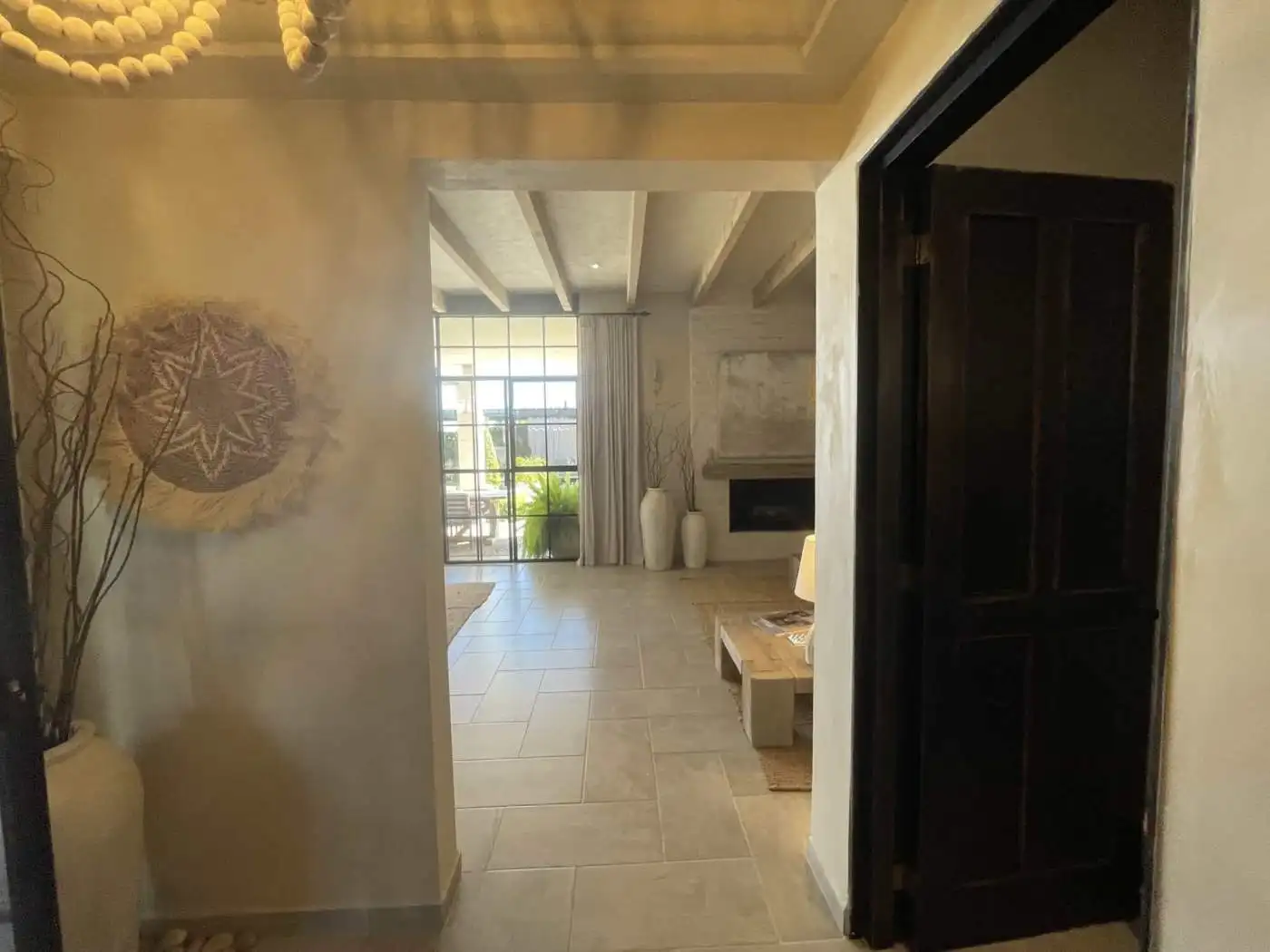 Modern living room with large windows and stylish decor, bright and spacious interior for comfortabl.