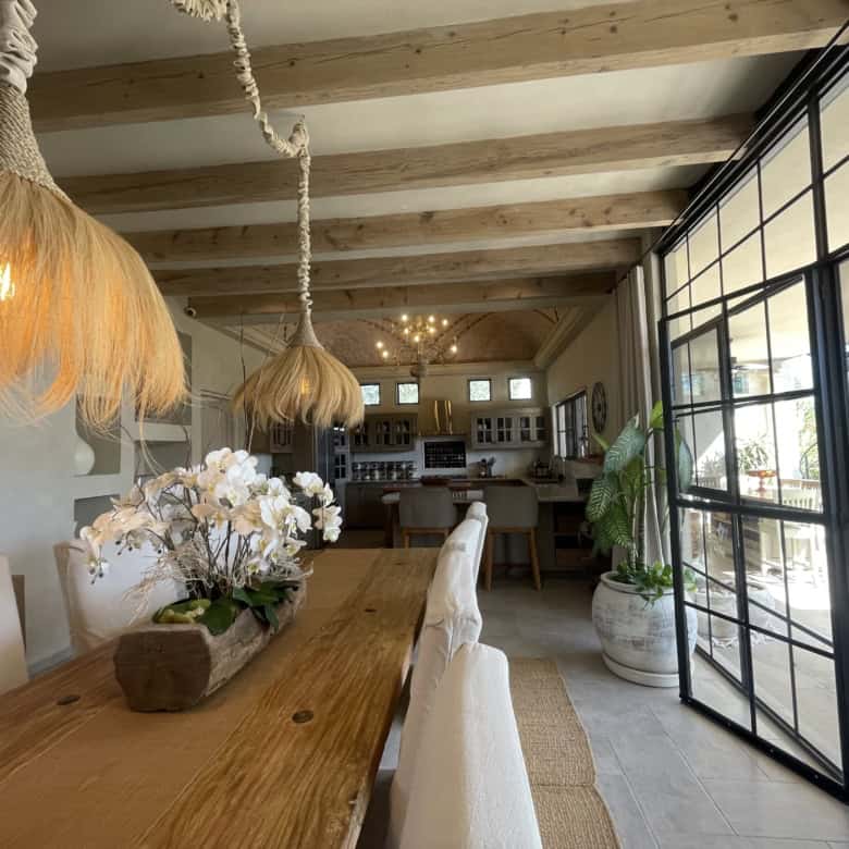 Bright and airy living space with wooden accents and large glass doors.