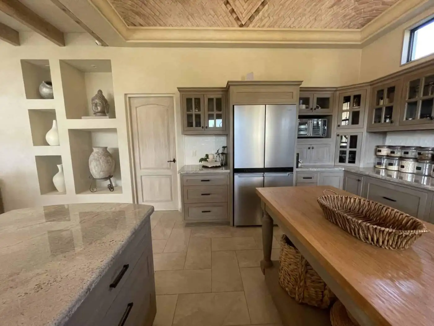 Modern kitchen with stainless steel refrigerator and wooden cabinetry for a stylish look.