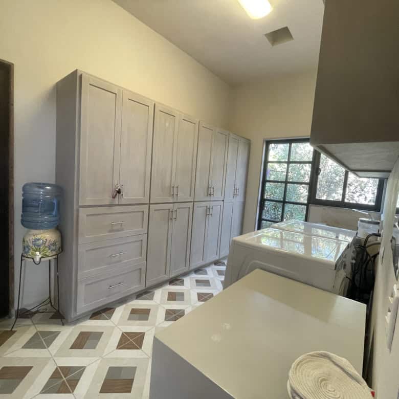 Laundry room with large storage cabinets, washer, and dryer in a bright, functional space.