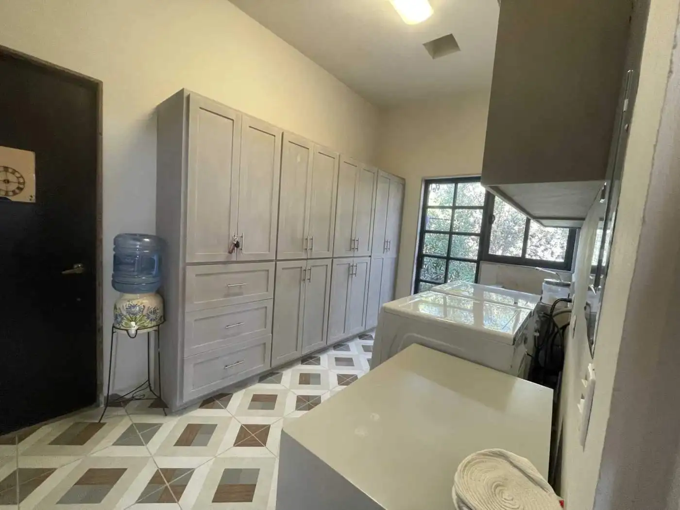 Laundry room with large storage cabinets, washer, and dryer in a bright, functional space.