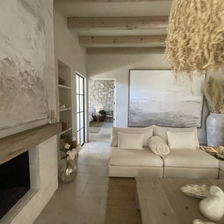 Bright and airy living room with neutral tones, wooden accents, and coastal decor elements.