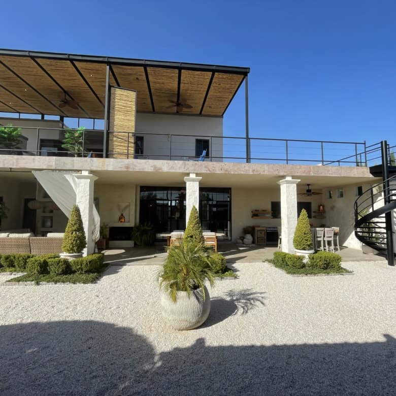 Luxury villa with outdoor terrace, garden, and modern design.