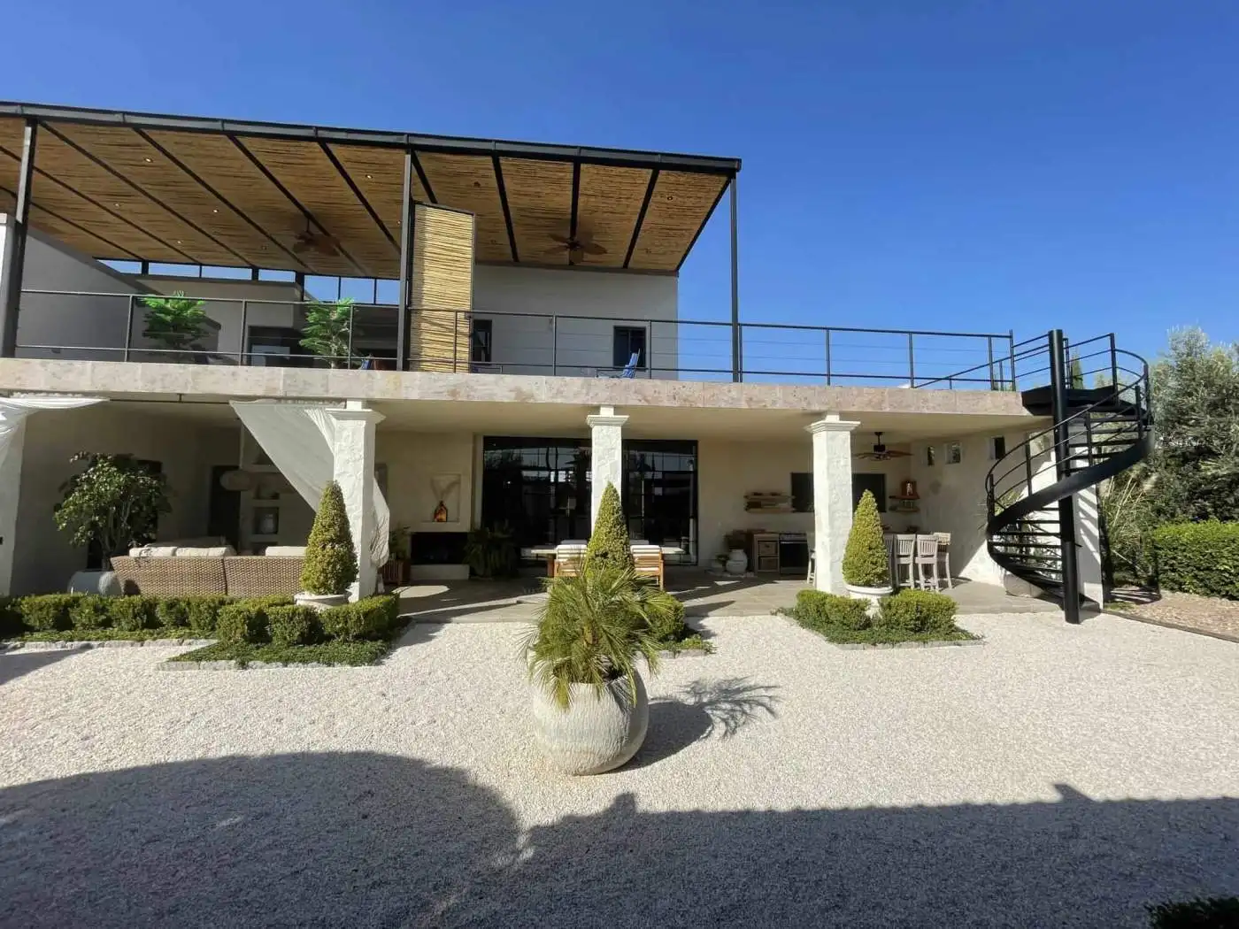Luxury villa with outdoor terrace, garden, and modern design.