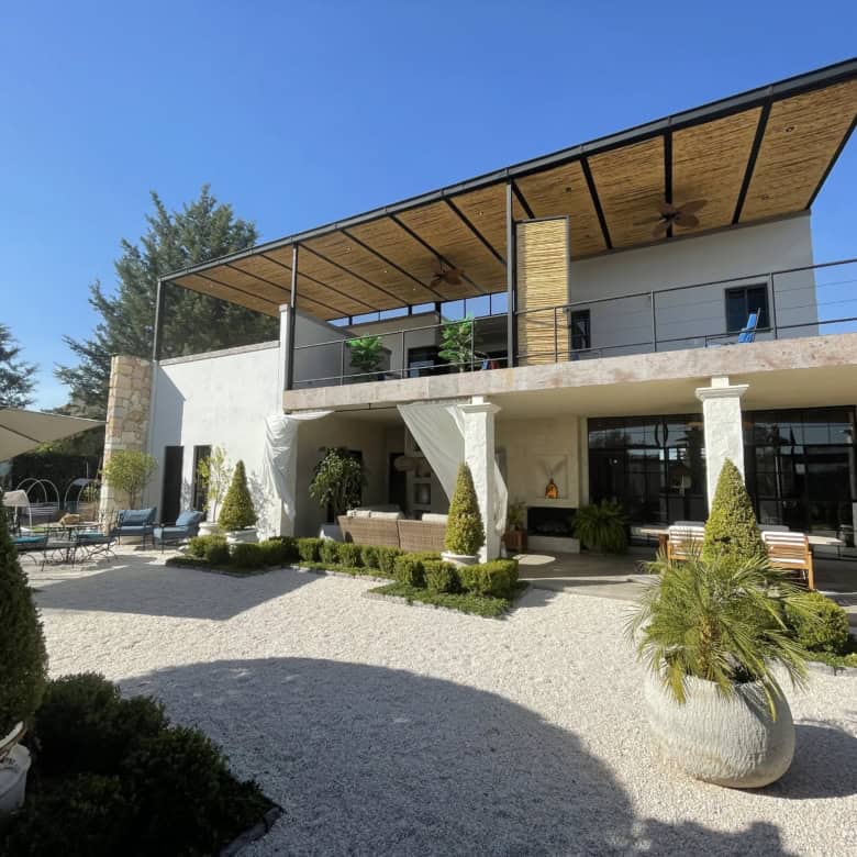 Modern villa with outdoor terrace and landscaped garden for sale.