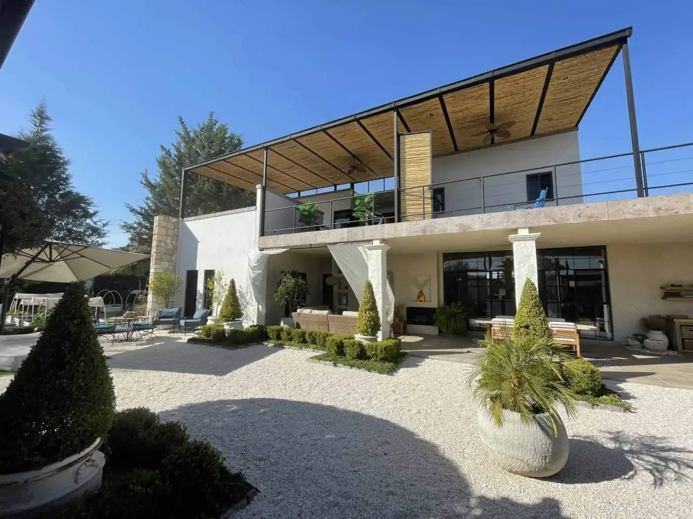Modern villa with outdoor terrace and landscaped garden for sale.