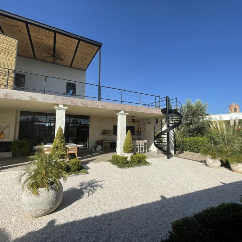 Luxury villa with spacious outdoor terrace and lush garden surroundings.