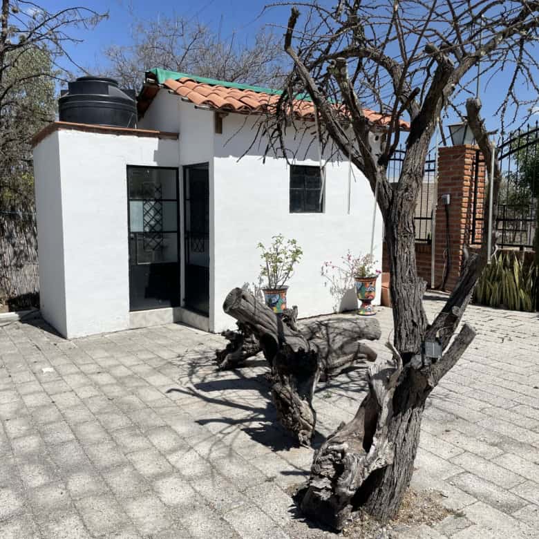 Cozy small house with a garden and outdoor seating area, perfect for a peaceful retreat.