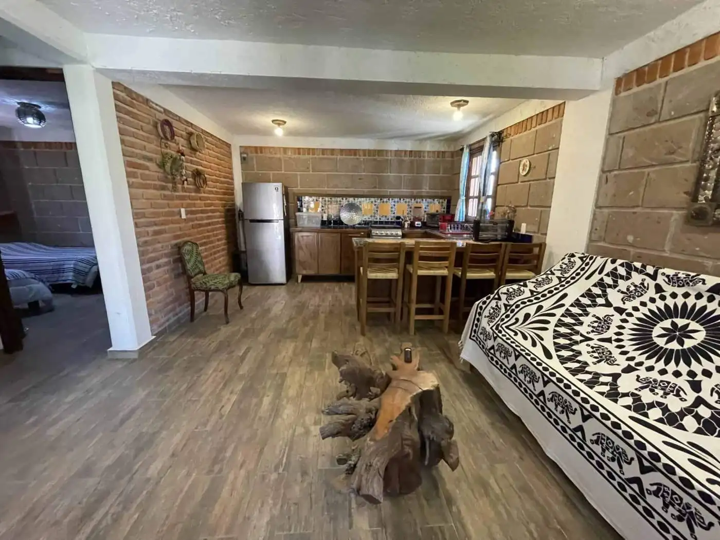 Spacious living and kitchen area with rustic decor and wooden furniture.