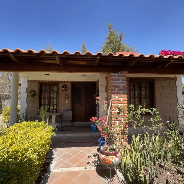 Cozy country house with garden, brick accents, and vibrant flowers. Perfect for peaceful living in a.