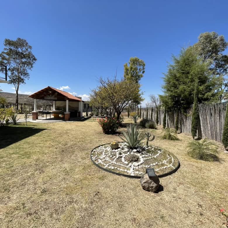 Beautiful backyard featuring a gazebo, lush trees, and well-maintained lawn for outdoor relaxation.