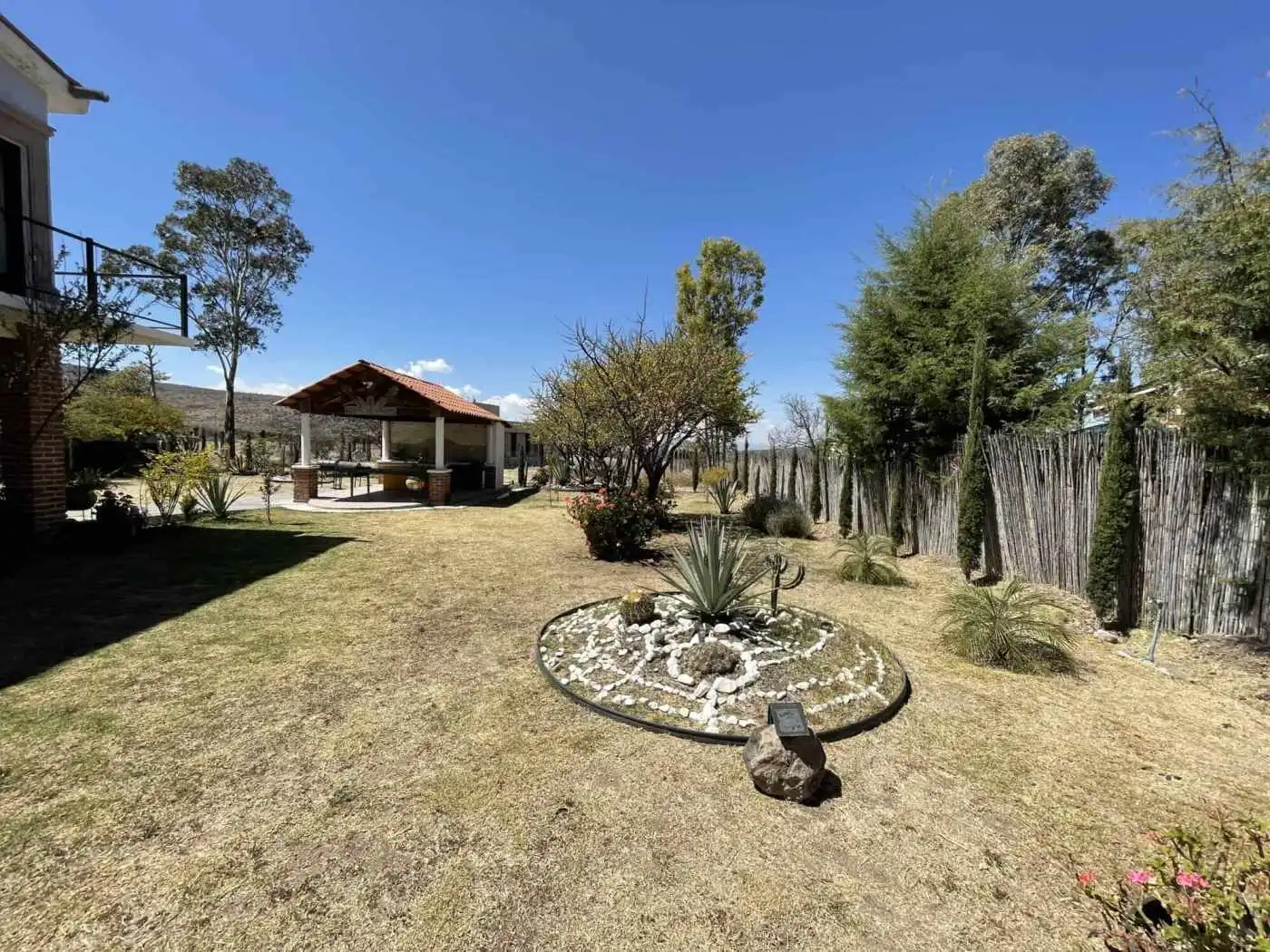 Beautiful backyard featuring a gazebo, lush trees, and well-maintained lawn for outdoor relaxation.