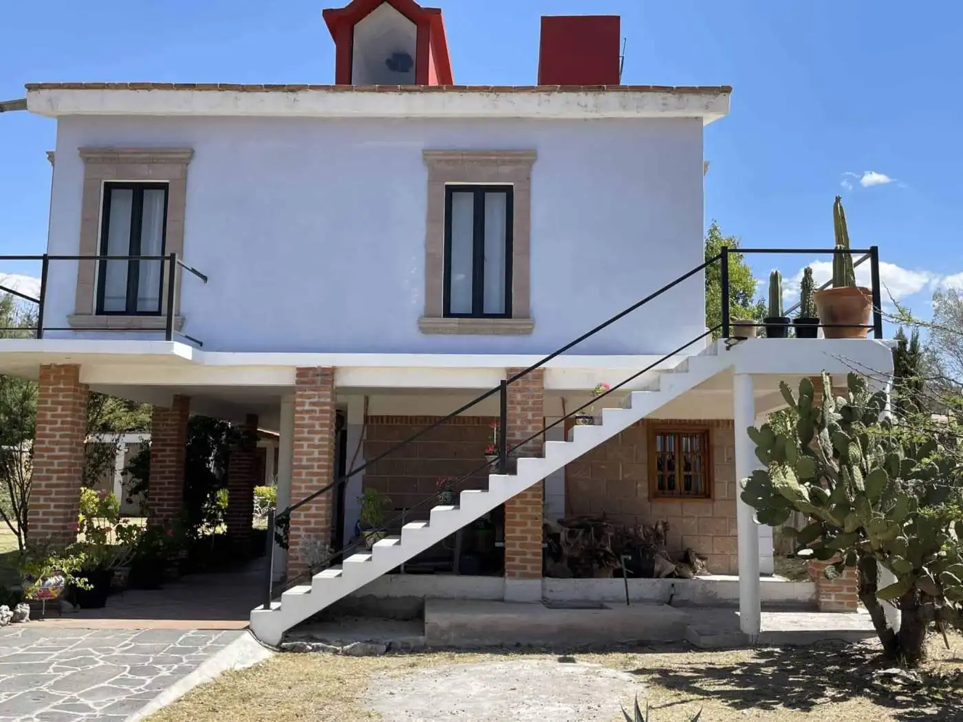 Beautiful two-story house with modern design and outdoor cactus garden. Perfect for buyers seeking a.