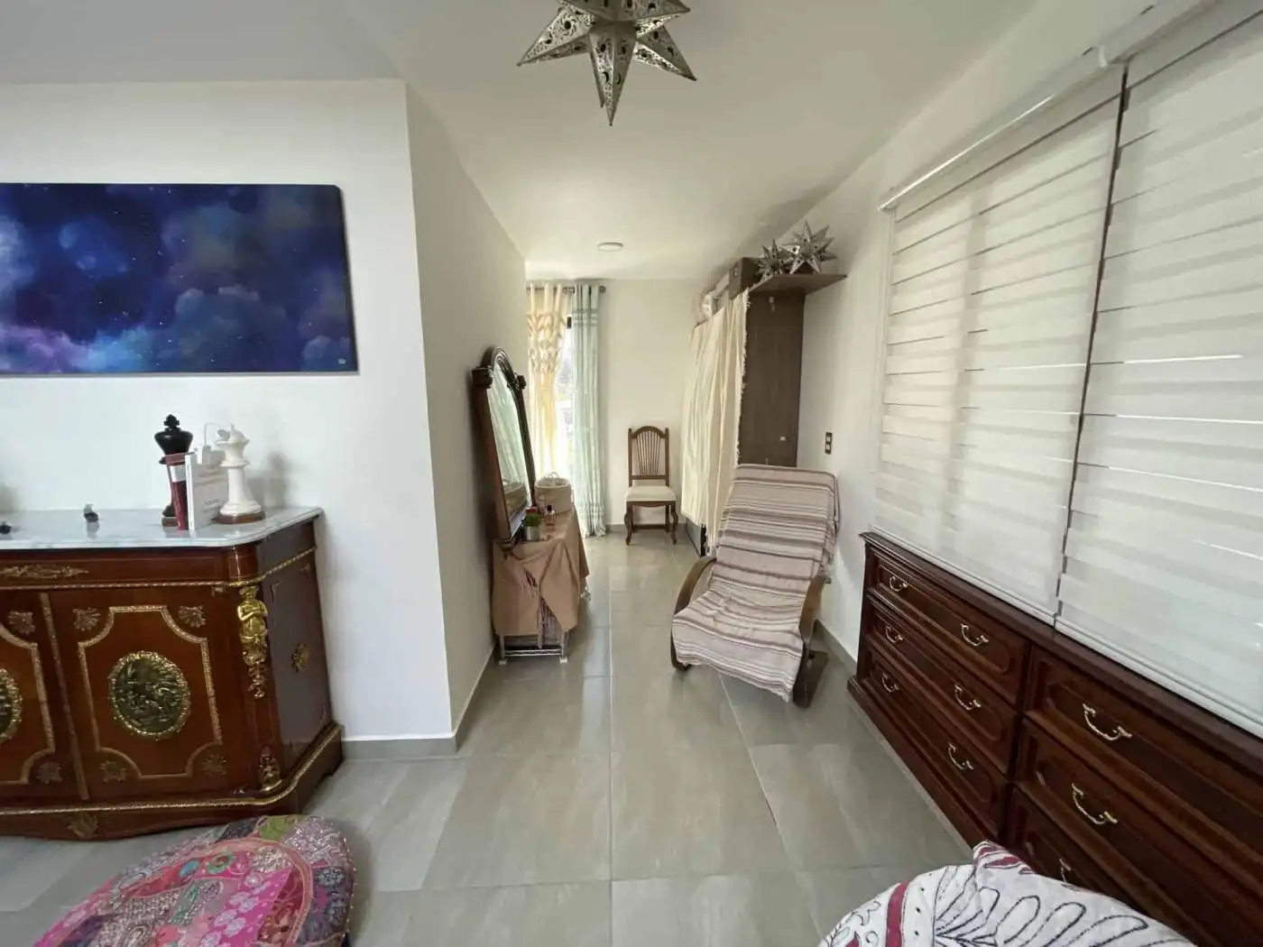 Elegant living room with classic furniture and large windows for bright, airy ambiance.