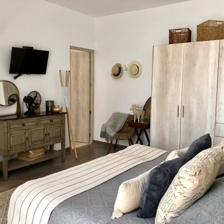 Bedroom with modern decor, large wardrobe, and cozy bedding setup.
