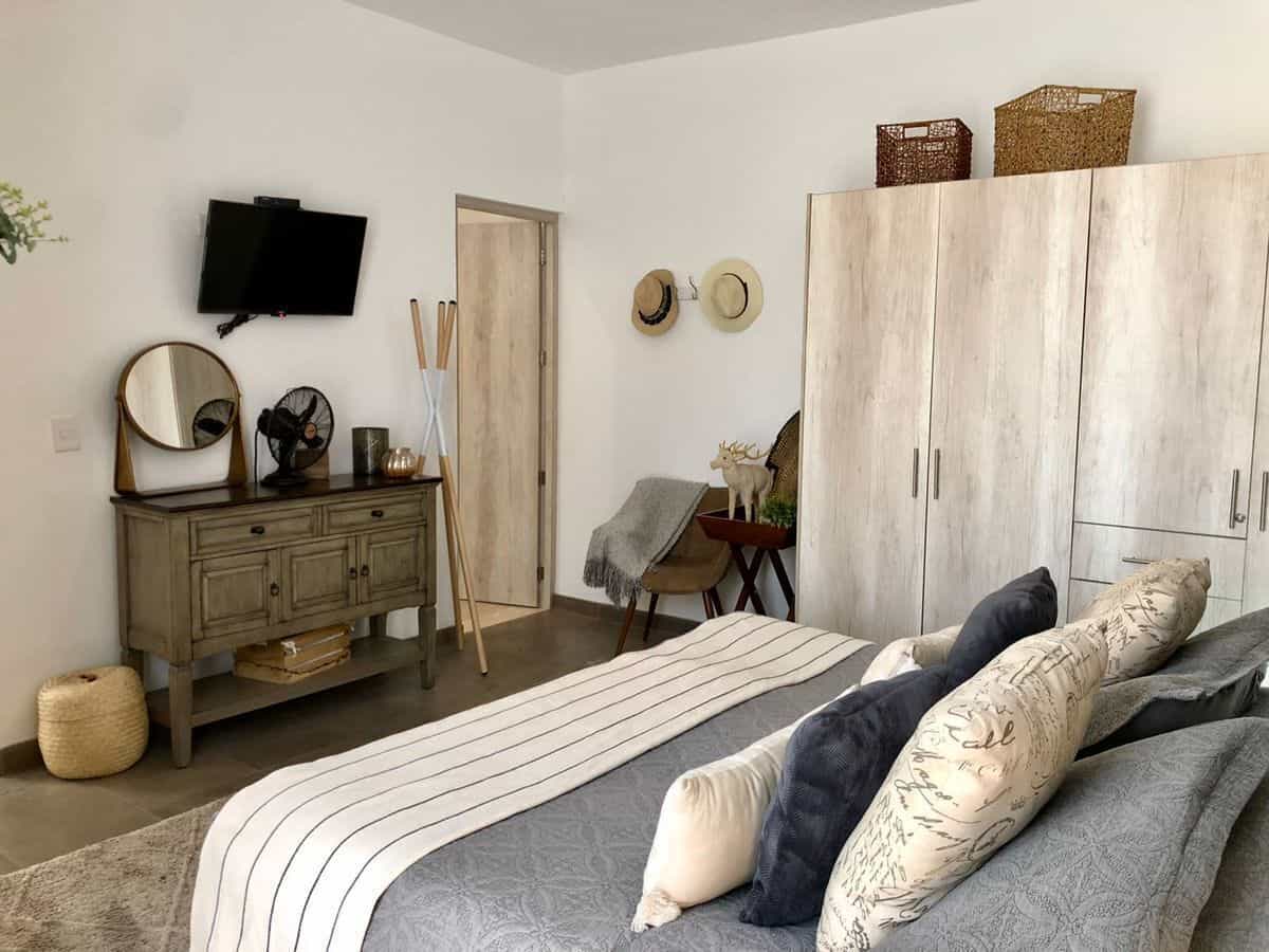 Bedroom with modern decor, large wardrobe, and cozy bedding setup.