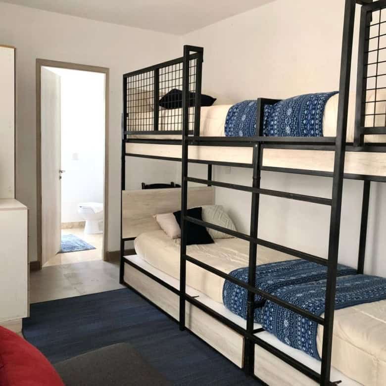 Bunk bed room with two levels, cozy bedding, and minimalist decor. Perfect for family or shared livi.