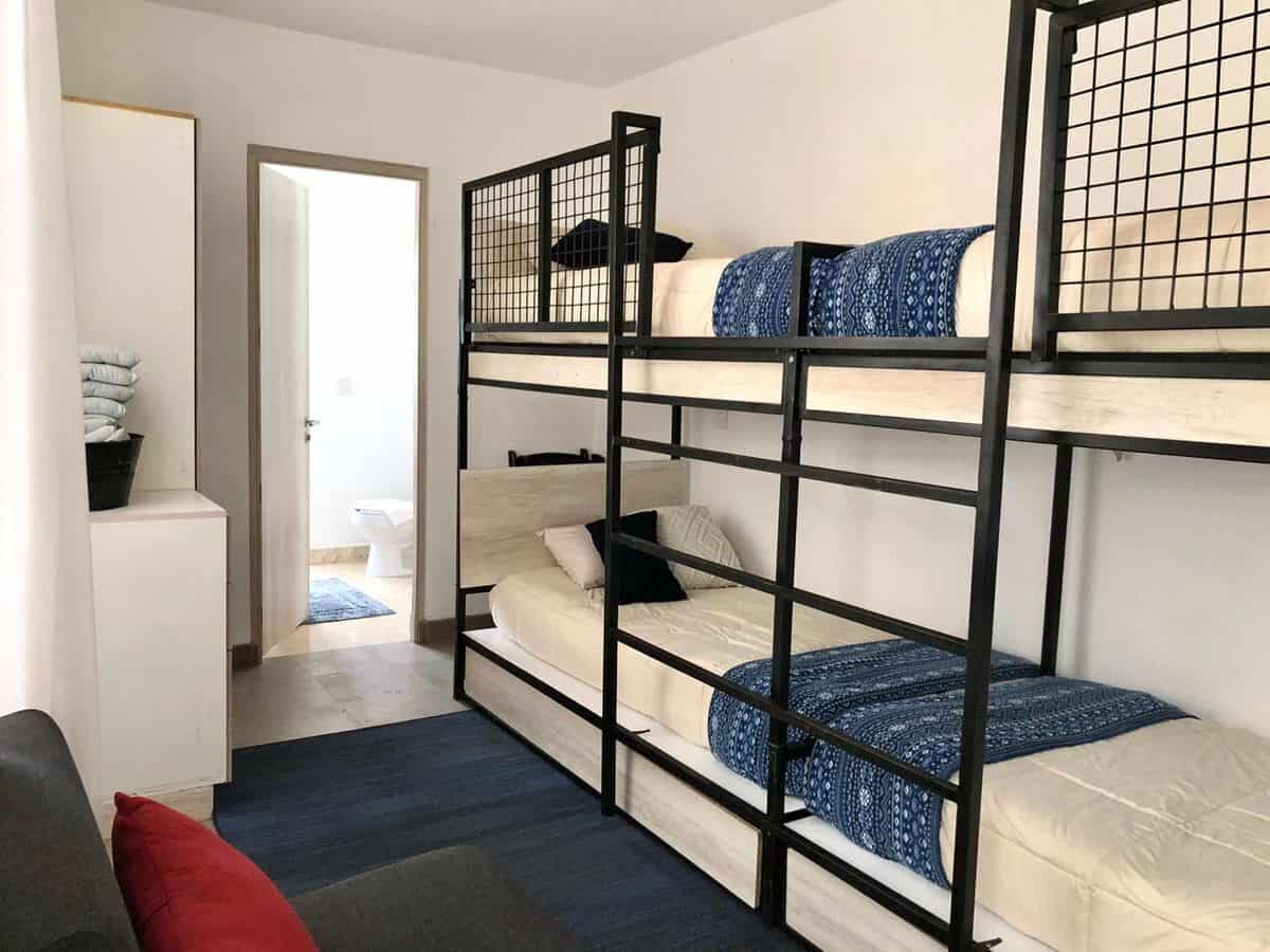 Bunk bed room with two levels, cozy bedding, and minimalist decor. Perfect for family or shared livi.