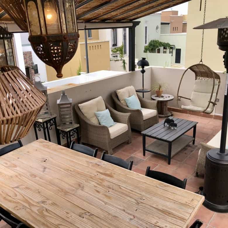 Outdoor terrace with comfortable seating, lanterns, and a parasol for relaxing evenings.