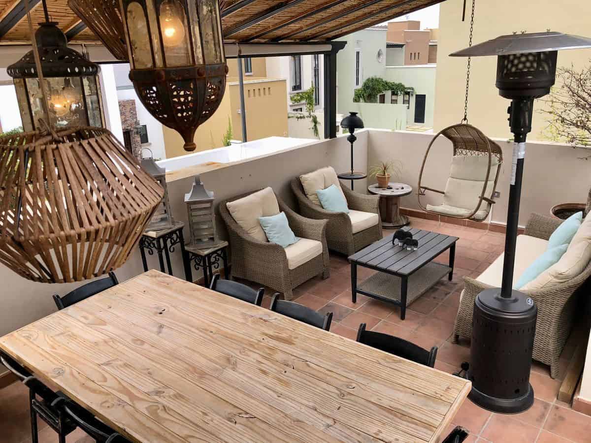 Outdoor terrace with comfortable seating, lanterns, and a parasol for relaxing evenings.