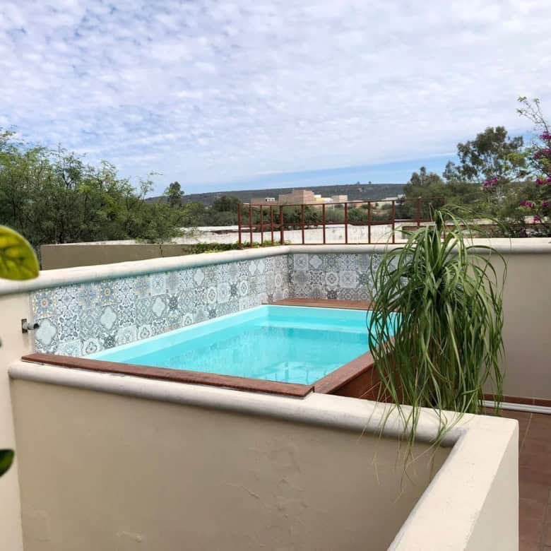 Rooftop pool overlooking lush landscape and sky, perfect for relaxation and leisure.