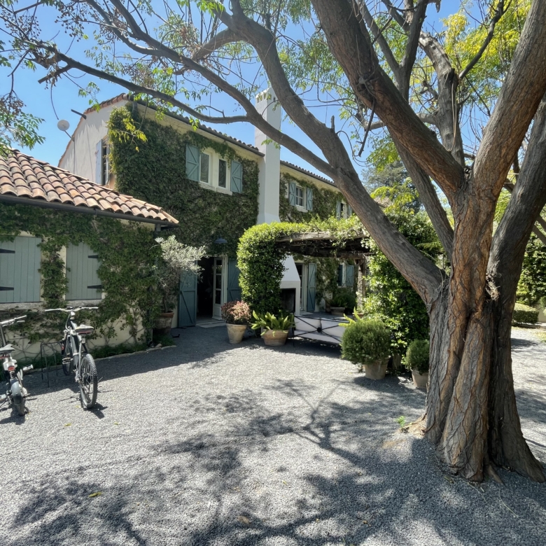 Beautiful European-style villa with lush garden and outdoor seating area.
