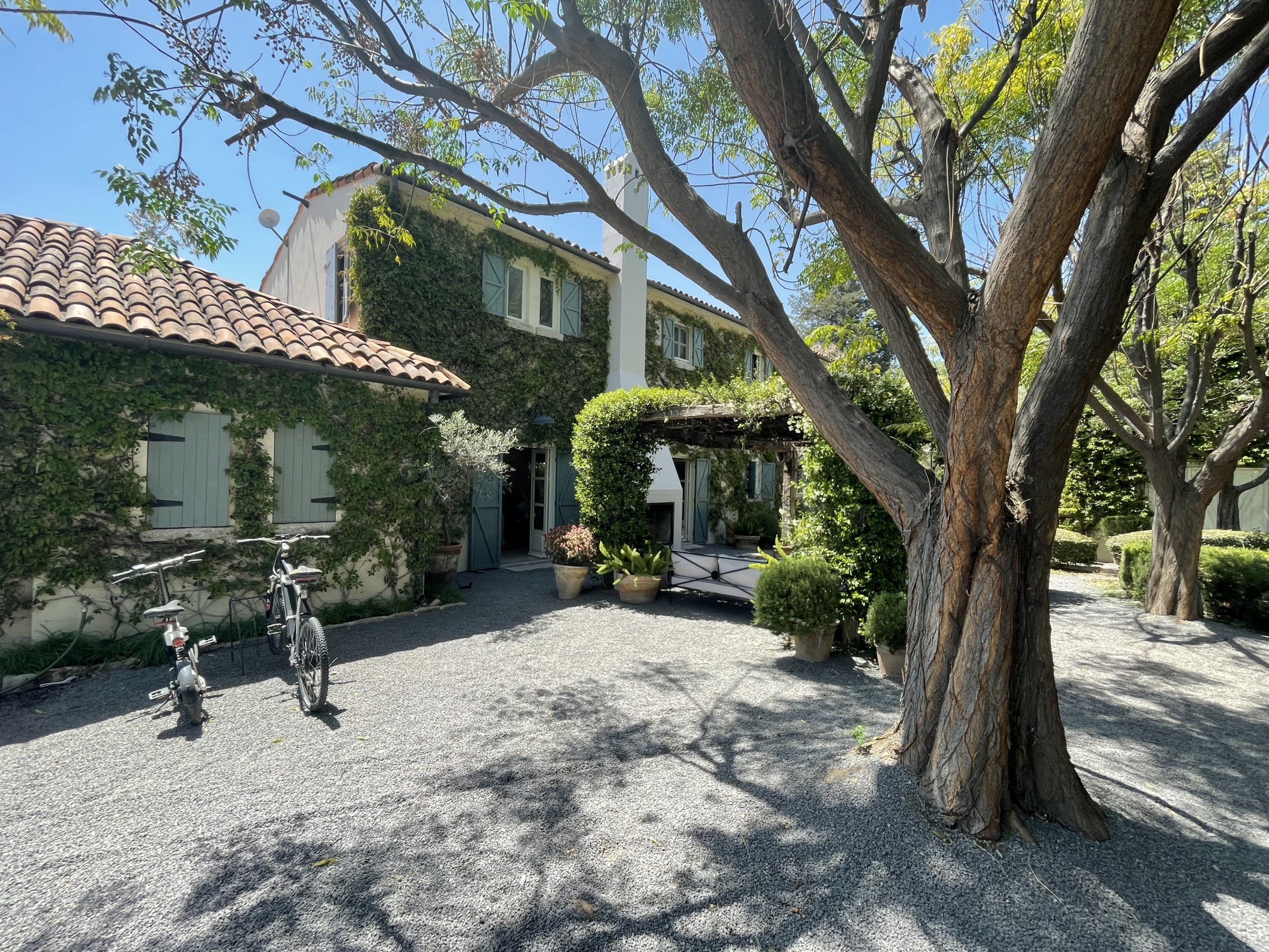 Beautiful European-style villa with lush garden and outdoor seating area.