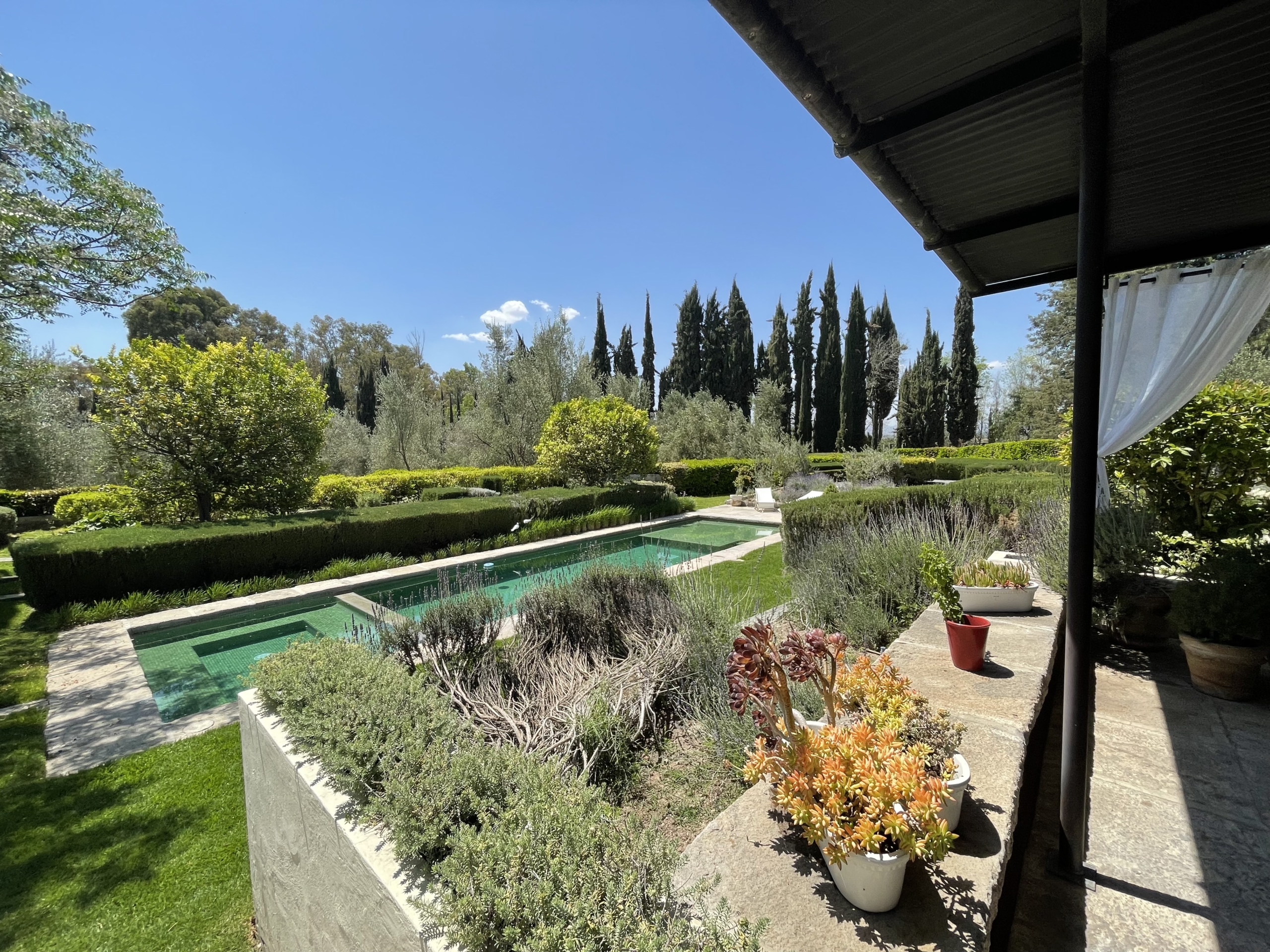 Luxury garden with pool and scenic landscape in Spain.