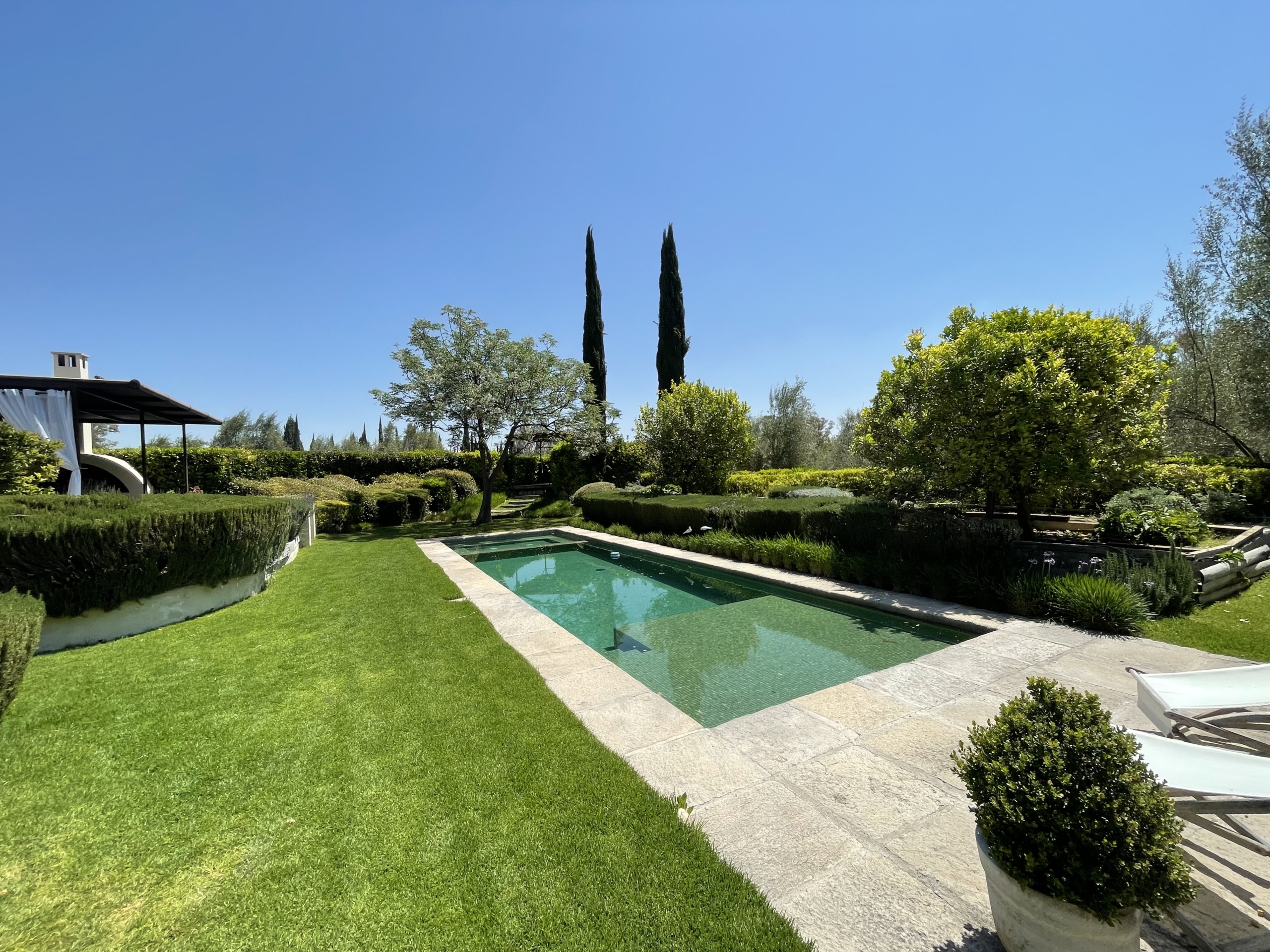 Luxury villa with private pool and lush garden for sale.