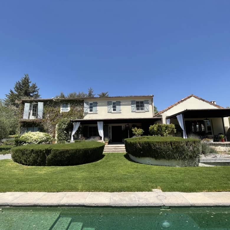 Luxury villa with swimming pool and landscaped garden in a serene setting.