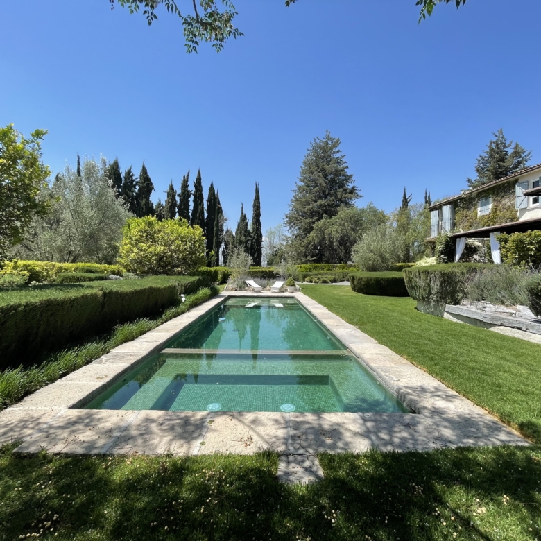 Luxury villa with private pool, surrounded by lush gardens and scenic landscape.