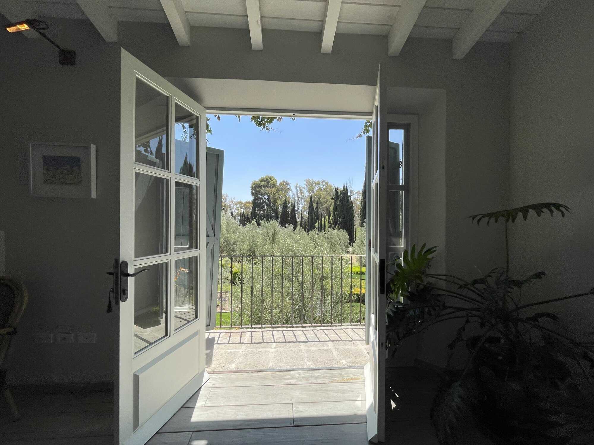 Open balcony with garden view and natural light.