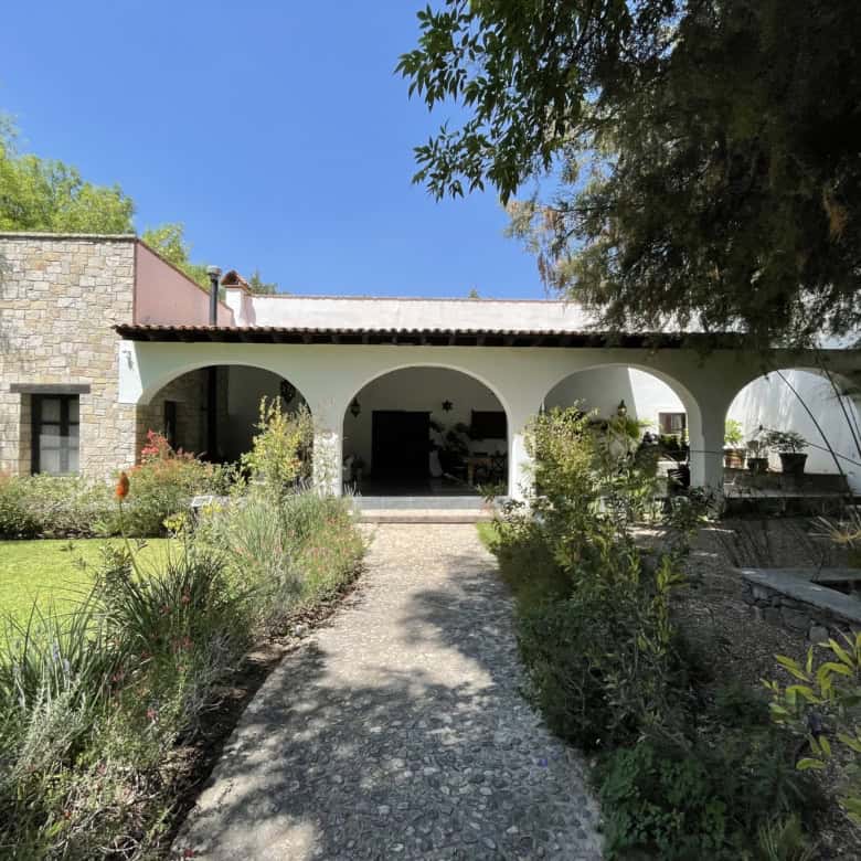 Spanish villa with lush garden and outdoor patio for relaxing and entertaining.