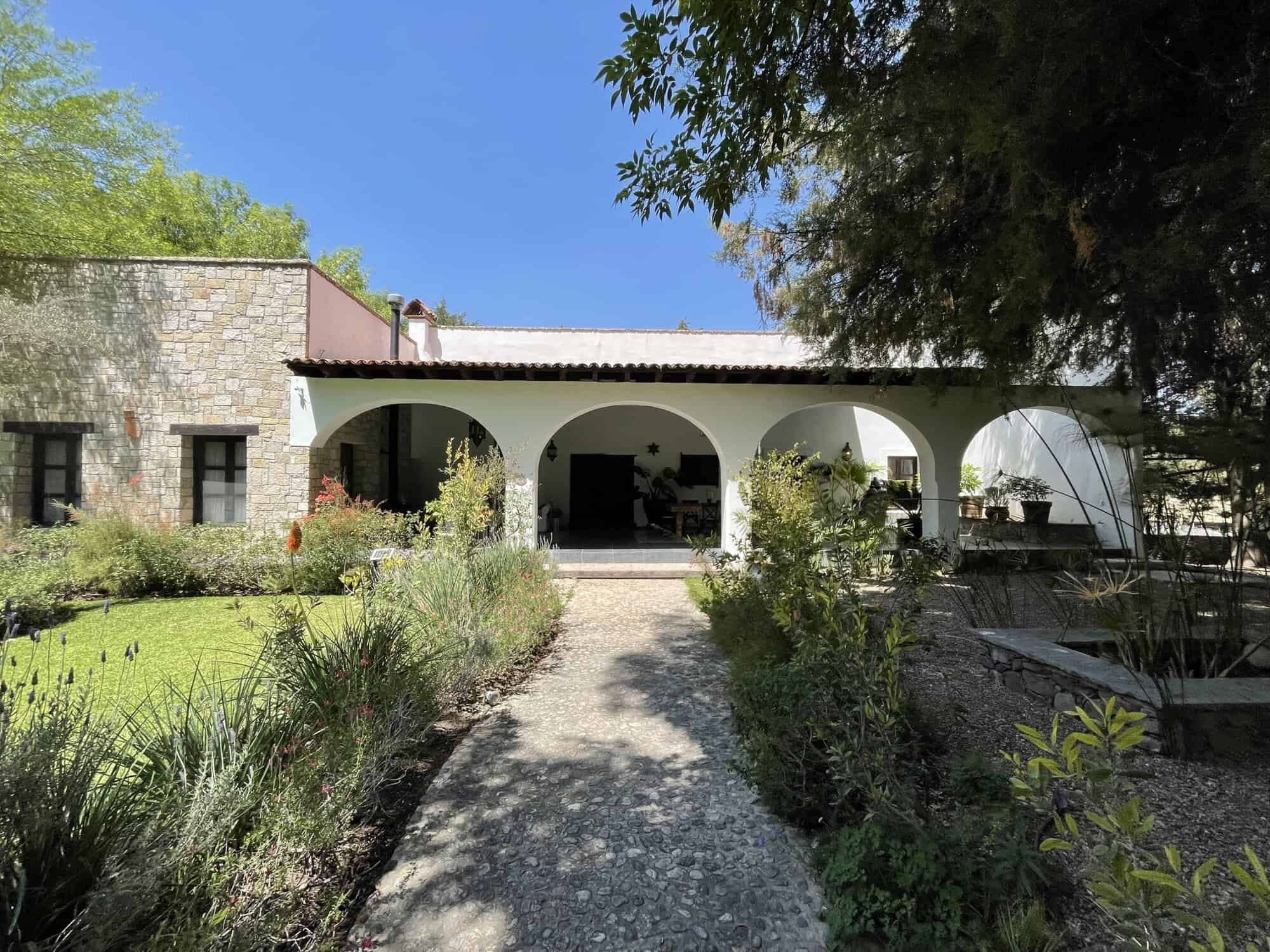 Spanish villa with lush garden and outdoor patio for relaxing and entertaining.