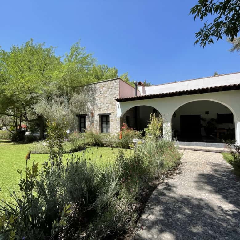 Charming country house with lush garden and shaded porch in Spain.